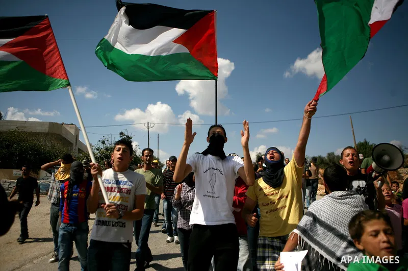 Palestinian youths clash with Israeli forces following a weekly demonstration against Israeli settlement expansion, in the West Bank village of Nabi Saleh, near the Jewish settlement of Halamish on September 30, 2011. Ph...