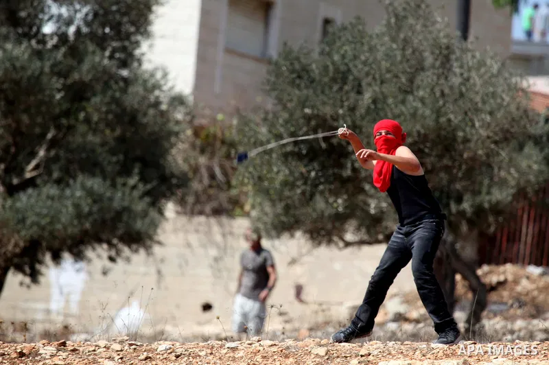 Palestinian youths clash with Israeli forces following a weekly demonstration against Israeli settlement expansion, in the West Bank village of Nabi Saleh, near the Jewish settlement of Halamish on September 30, 2011. Ph...