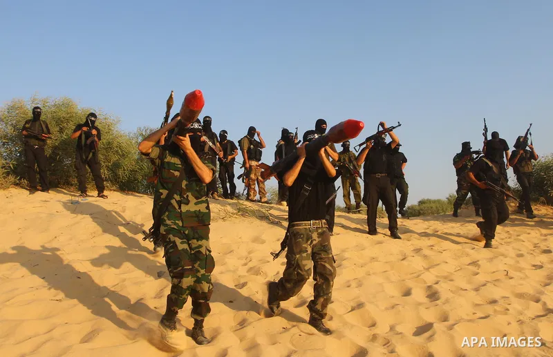 Palestinian militants from the Popular Resistance Movement participate in a training session in the southern Gaza Strip town of Khan Younis on Sept.30,2011. Israel on Tuesday approved construction of 1,100 homes for Jews...