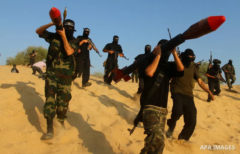 Palestinian militants from the Popular Resistance Movement participate in a training session in the southern Gaza Strip town of Khan Younis on Sept.30,2011. Israel on Tuesday approved construction of 1,100 homes for Jews...