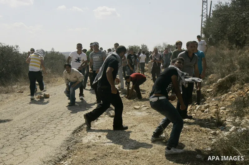 Palestinian stone throwers clash with Israeli soldiers on September 30, 2011 in the West Bank village of Kfar Kadum. Photo by Wagdi Eshtayah