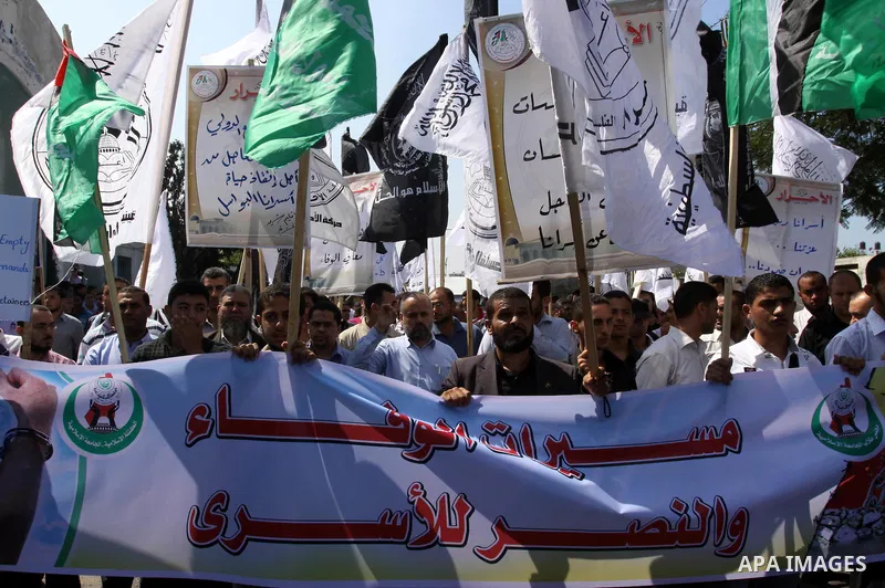 Families of Palestinian prisoners held in Israeli jails take part during a protest outside the International Committee of the Red Cross (ICRC) offices in Gaza City on October 3, 2011 in support of prisoners on hunger str...