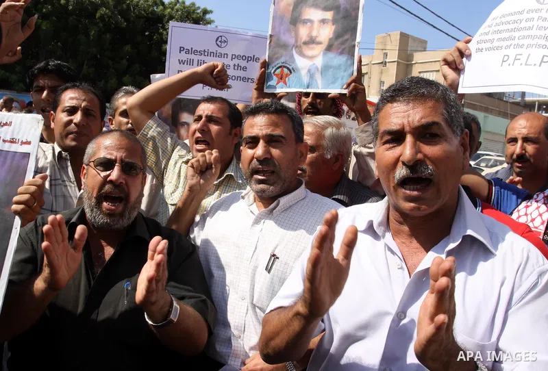 Families of Palestinian prisoners held in Israeli jails shout slogans during a protest outside the International Committee of the Red Cross (ICRC) offices in Gaza City on October 3, 2011 in support of prisoners on hunger...