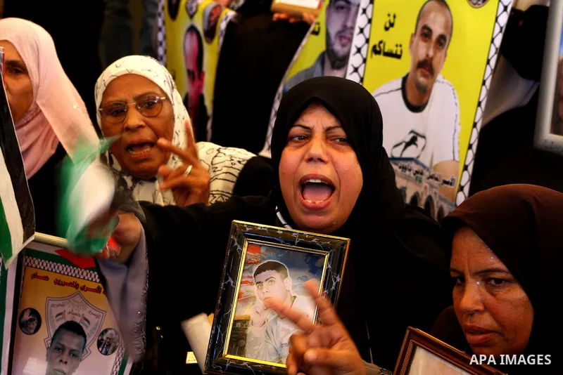 Palestinians take part in a protest at the Red Cross headquarters in Gaza City on October 3, 2011, to show their solidarity with Palestinian prisoners held in Israeli jails. On Wednesday, Palestinian prisoners in Israel...