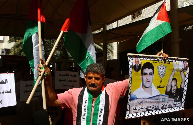 A Palestinian man takes part in a protest at the Red Cross headquarters in Gaza City on October 3, 2011, to show their solidarity with Palestinian prisoners held in Israeli jails. On Wednesday, Palestinian prisoners in I...