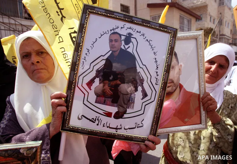 Palestinians take part in a protest in the West Bank city of Nablus on October 3, 2011, to show their solidarity with Palestinian prisoners held in Israeli jails. On Wednesday, Palestinian prisoners in Israel went on a h...