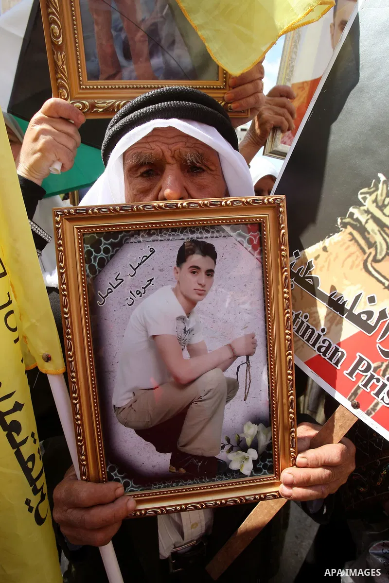 A Palestinian man takes part in a protest in the West Bank city of Nablus on October 3, 2011, to show their solidarity with Palestinian prisoners held in Israeli jails. On Wednesday, Palestinian prisoners in Israel went...