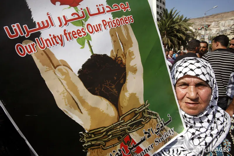 A Palestinian woman takes part in a protest in the West Bank city of Nablus on October 3, 2011, to show their solidarity with Palestinian prisoners held in Israeli jails. On Wednesday, Palestinian prisoners in Israel wen...