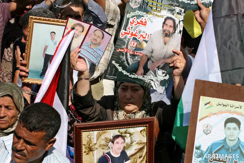 Palestinians attend a demonstration calling for the release of prisoners held in Israeli jails and in support of inmates in hunger strike, on October 3, 2011 in the West Bank city of Ramallah. Thousands of Palestinian in...