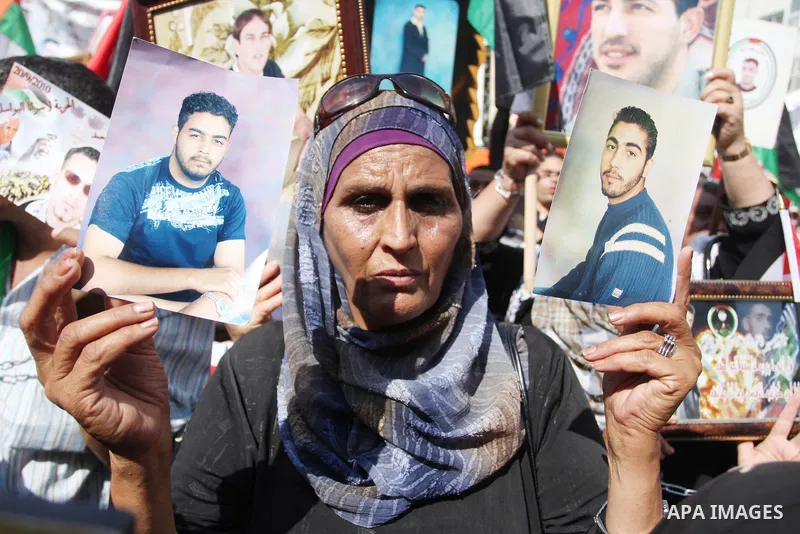 Palestinians attend a demonstration calling for the release of prisoners held in Israeli jails and in support of inmates in hunger strike, on October 3, 2011 in the West Bank city of Ramallah. Thousands of Palestinian in...