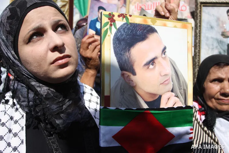 Palestinians attend a demonstration calling for the release of prisoners held in Israeli jails and in support of inmates in hunger strike, on October 3, 2011 in the West Bank city of Ramallah. Thousands of Palestinian in...