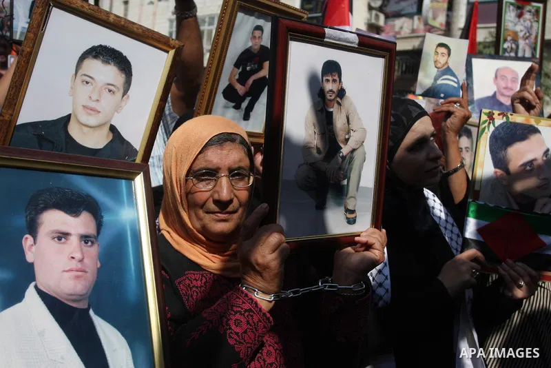 Palestinians attend a demonstration calling for the release of prisoners held in Israeli jails and in support of inmates in hunger strike, on October 3, 2011 in the West Bank city of Ramallah. Thousands of Palestinian in...