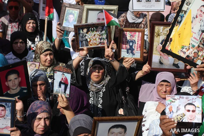 Palestinians attend a demonstration calling for the release of prisoners held in Israeli jails and in support of inmates in hunger strike, on October 3, 2011 in the West Bank city of Ramallah. Thousands of Palestinian in...