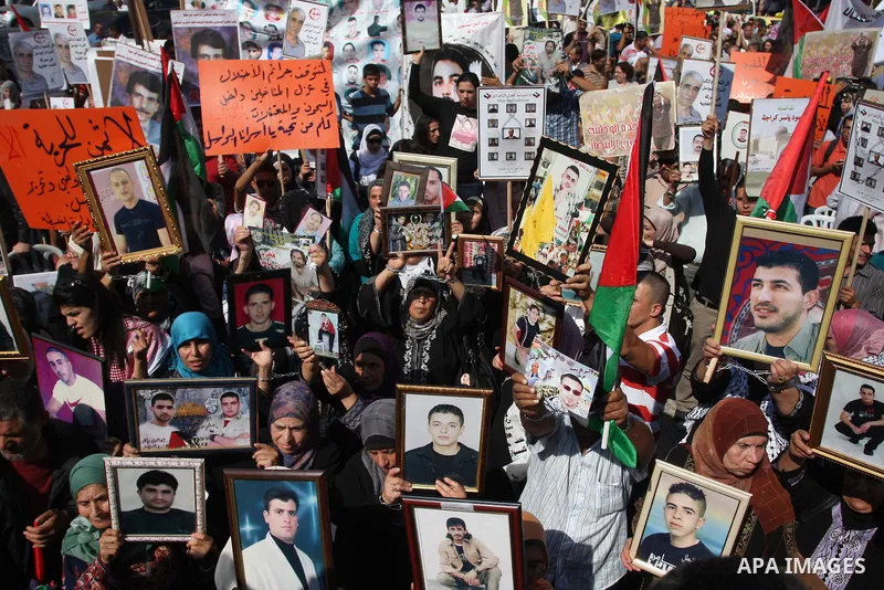Palestinians attend a demonstration calling for the release of prisoners held in Israeli jails and in support of inmates in hunger strike, on October 3, 2011 in the West Bank city of Ramallah. Thousands of Palestinian in...