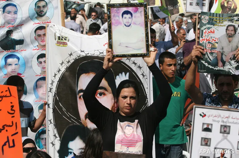 Palestinians attend a demonstration calling for the release of prisoners held in Israeli jails and in support of inmates in hunger strike, on October 3, 2011 in the West Bank city of Ramallah. Thousands of Palestinian in...
