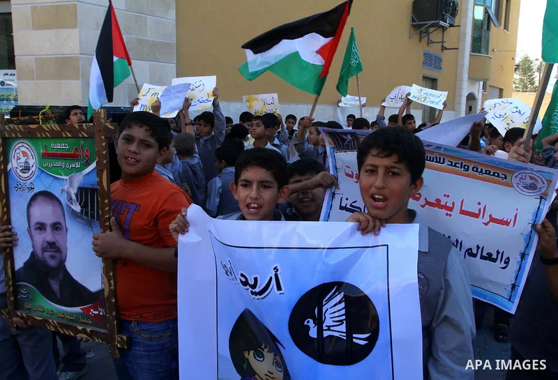 Palestinian students take part in a protest demanding for release of Palestinian prisoners in Israeli jails, at the Red Cross head headquarters in Gaza City on Oct. 4, 2011. Palestinians continue their protests in the We...