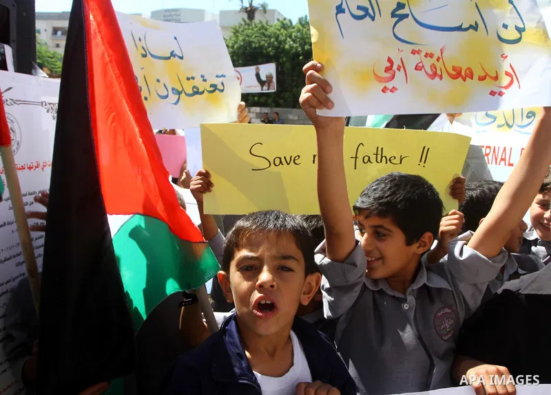 Palestinian students take part in a protest demanding for release of Palestinian prisoners in Israeli jails, at the Red Cross head headquarters in Gaza City on Oct. 4, 2011. Palestinians continue their protests in the We...