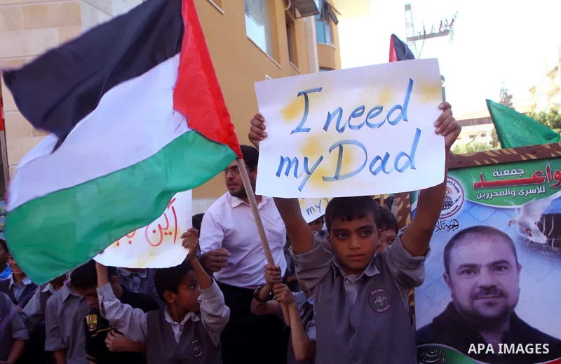 Palestinian students take part in a protest demanding for release of Palestinian prisoners in Israeli jails, at the Red Cross head headquarters in Gaza City on Oct. 4, 2011. Palestinians continue their protests in the We...