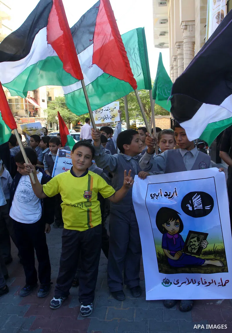 Palestinian students take part in a protest demanding for release of Palestinian prisoners in Israeli jails, at the Red Cross head headquarters in Gaza City on Oct. 4, 2011. Palestinians continue their protests in the We...