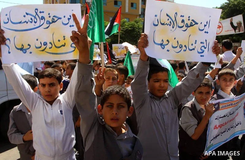 Palestinian students take part in a protest demanding for release of Palestinian prisoners in Israeli jails, at the Red Cross head headquarters in Gaza City on Oct. 4, 2011. Palestinians continue their protests in the We...