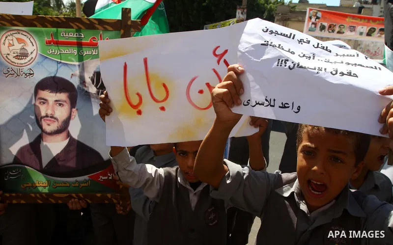 Palestinian students take part in a protest demanding for release of Palestinian prisoners in Israeli jails, at the Red Cross head headquarters in Gaza City on Oct. 4, 2011. Palestinians continue their protests in the We...