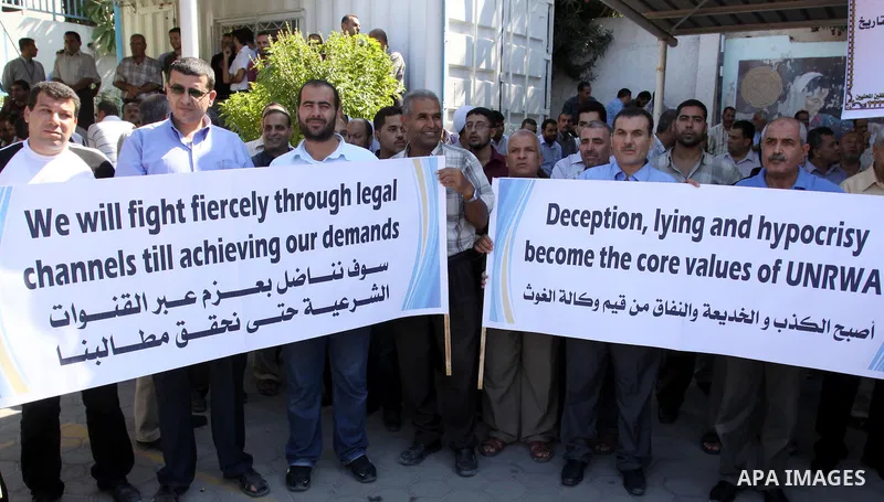 Palestinians take part in a protest against the decision to stop the head of the Federation of staff, Suhail al-Hindi to work temporarily, in front of the UNRWA headquarters in Gaza City on Oct. 5,2011. Union officials c...