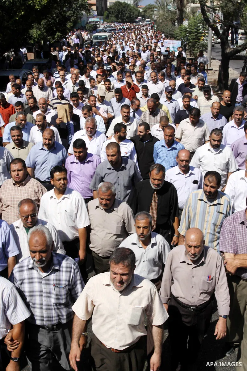 Palestinians take part in a protest against the decision to stop the head of the Federation of staff, Suhail al-Hindi to work temporarily, in front of the UNRWA headquarters in Gaza City on Oct. 5,2011. Union officials c...