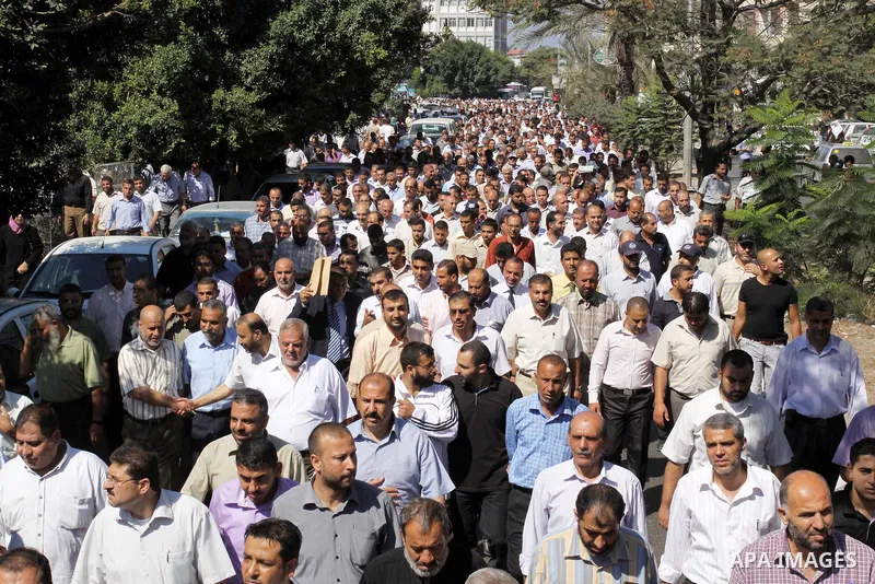 Palestinians take part in a protest against the decision to stop the head of the Federation of staff, Suhail al-Hindi to work temporarily, in front of the UNRWA headquarters in Gaza City on Oct. 5,2011. Union officials c...