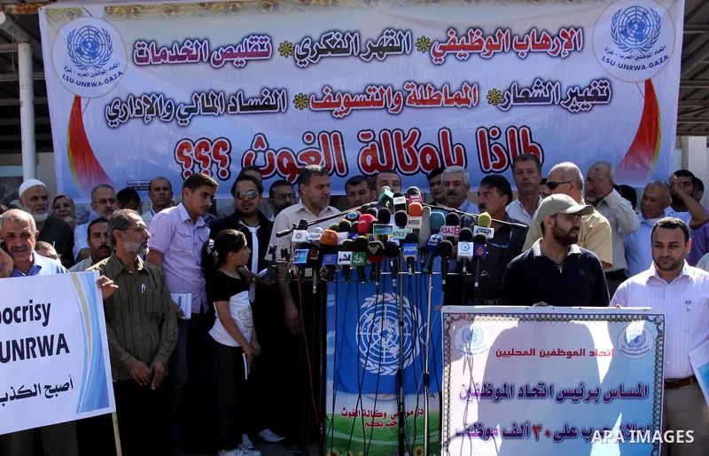 Palestinians take part in a protest against the decision to stop the head of the Federation of staff, Suhail al-Hindi to work temporarily, in front of the UNRWA headquarters in Gaza City on Oct. 5,2011. Union officials c...
