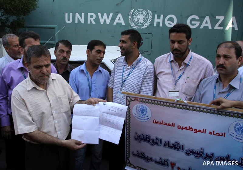 Palestinians take part in a protest against the decision to stop the head of the Federation of staff, Suhail al-Hindi to work temporarily, in front of the UNRWA headquarters in Gaza City on Oct. 5,2011. Union officials c...