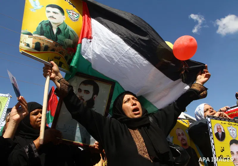 Palestinians take part in a protest near the Erez border crossing between Israel and northern Gaza Strip October 5, 2011, to show their solidarity with Palestinian prisoners held in Israeli jails. Hundreds of Palestinian...