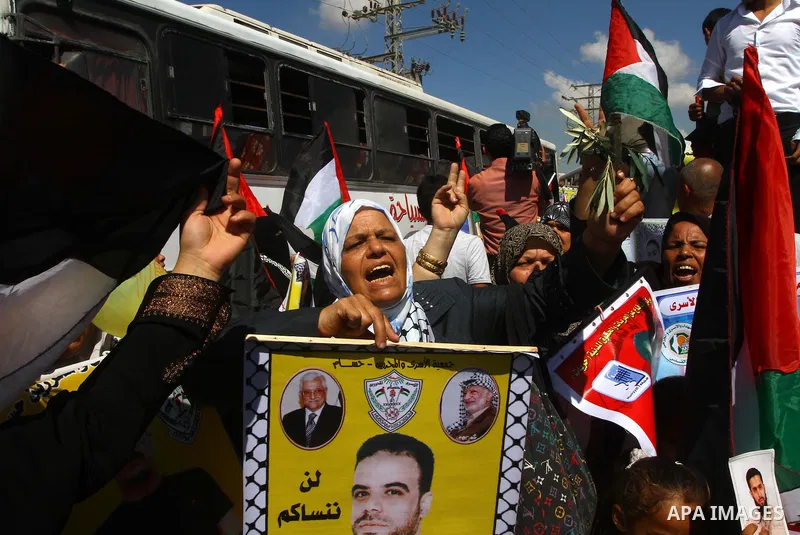 Palestinians take part in a protest near the Erez border crossing between Israel and northern Gaza Strip October 5, 2011, to show their solidarity with Palestinian prisoners held in Israeli jails. Hundreds of Palestinian...
