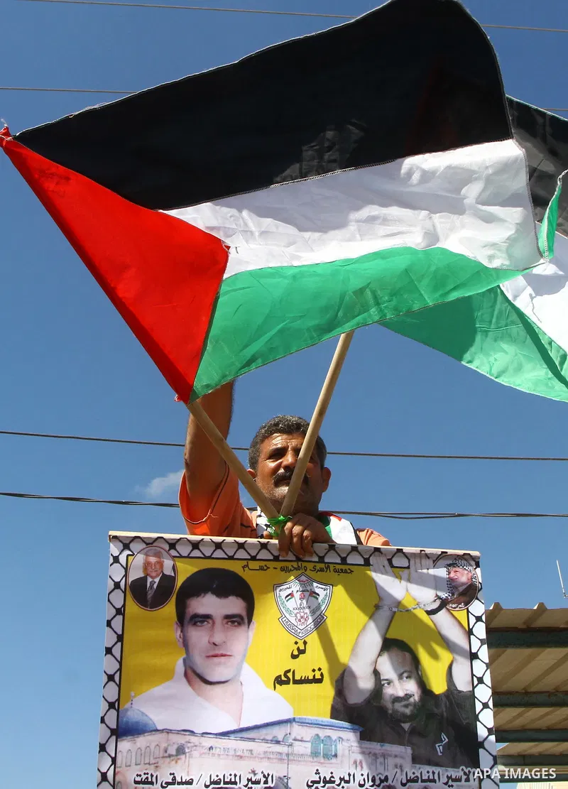 Palestinians take part in a protest near the Erez border crossing between Israel and northern Gaza Strip October 5, 2011, to show their solidarity with Palestinian prisoners held in Israeli jails. Hundreds of Palestinian...