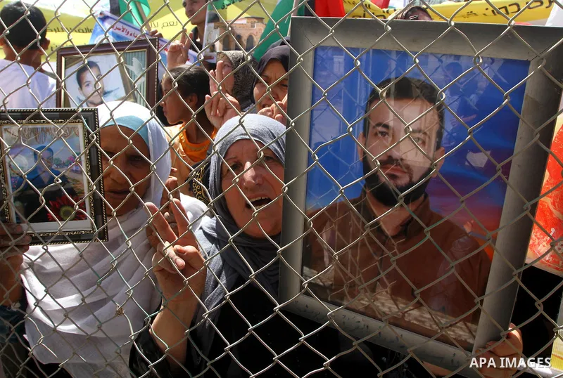 Palestinians take part in a protest near the Erez border crossing between Israel and northern Gaza Strip October 5, 2011, to show their solidarity with Palestinian prisoners held in Israeli jails. Hundreds of Palestinian...