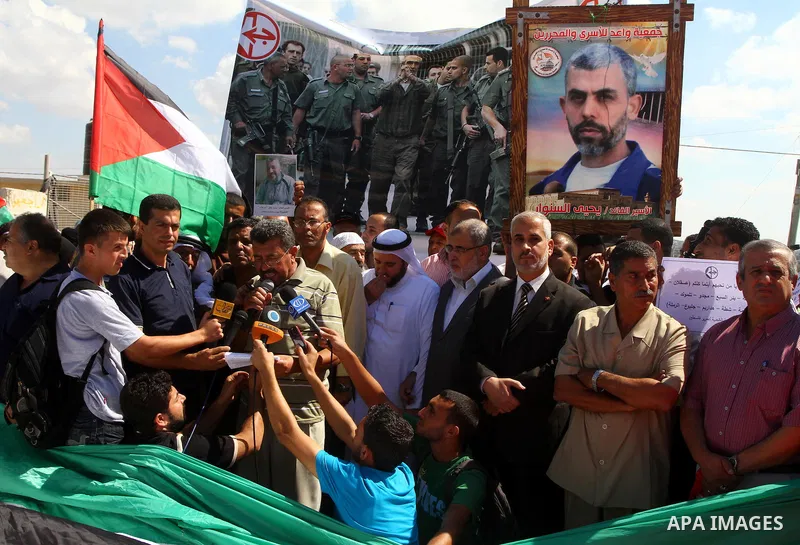 Palestinians take part in a protest near the Erez border crossing between Israel and northern Gaza Strip October 5, 2011, to show their solidarity with Palestinian prisoners held in Israeli jails. Hundreds of Palestinian...
