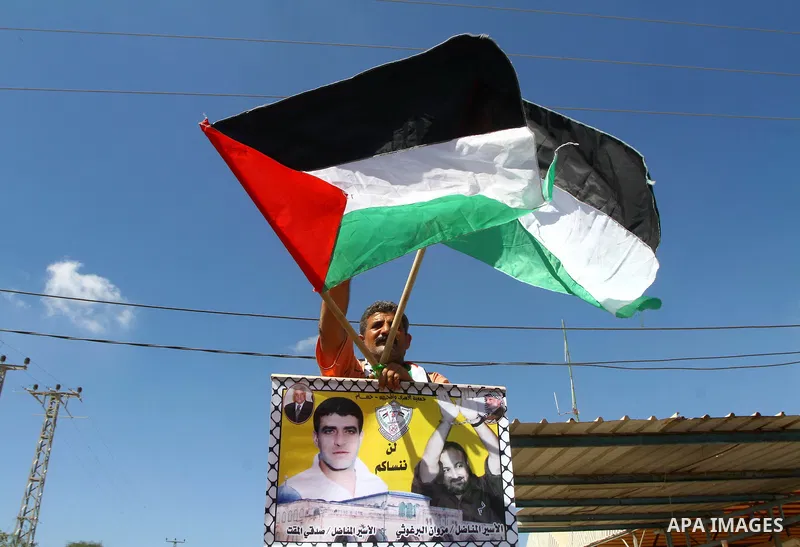 Palestinians take part in a protest near the Erez border crossing between Israel and northern Gaza Strip October 5, 2011, to show their solidarity with Palestinian prisoners held in Israeli jails. Hundreds of Palestinian...