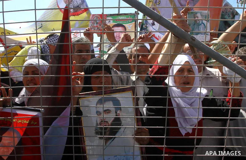 Palestinians take part in a protest near the Erez border crossing between Israel and northern Gaza Strip October 5, 2011, to show their solidarity with Palestinian prisoners held in Israeli jails. Hundreds of Palestinian...