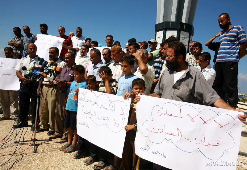 Palestinian fishermen participate in a press conference at the Gaza Seaport on Oct. 5, 2011 against the violations of Israeli forces against the Palestinian fishermen in the Mediterranean Sea. Photo by Majdi Fathi.i