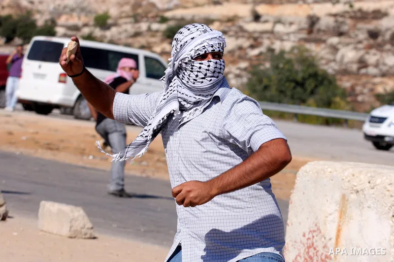 Palestinian protestors clash with Israeli forces during a demonstration calling for the release of prisoners held in Israeli jails and in support of inmates in hunger strike, on October 5, 2011 near Israel's Ofer prison,...