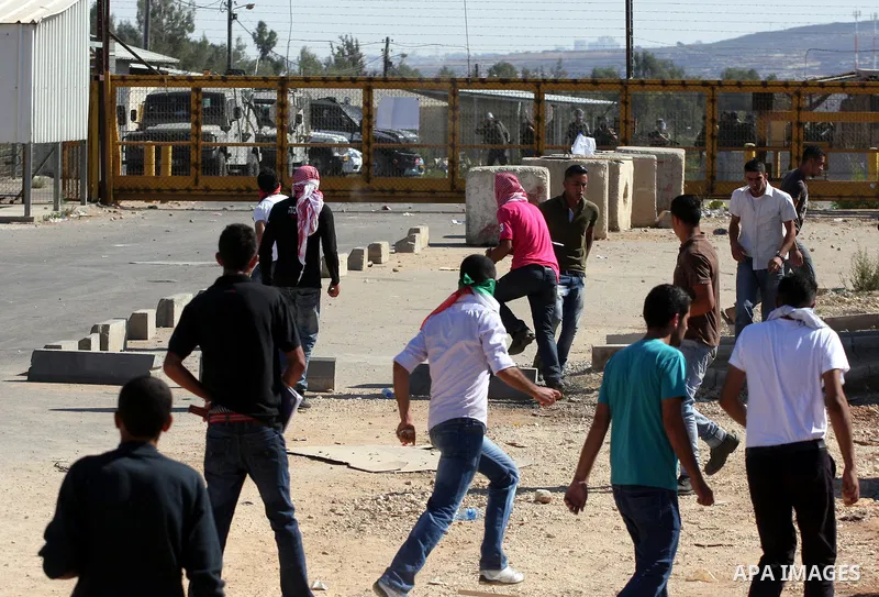Palestinian protestors clash with Israeli forces during a demonstration calling for the release of prisoners held in Israeli jails and in support of inmates in hunger strike, on October 5, 2011 near Israel's Ofer prison,...