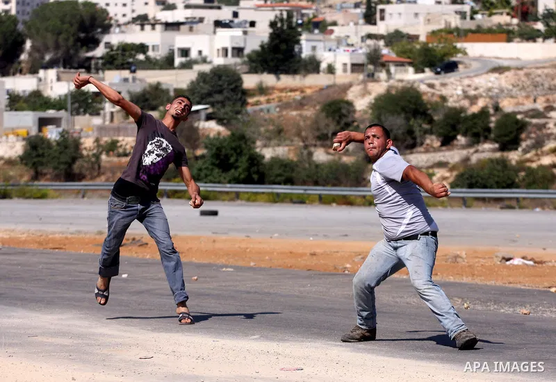 Palestinian protestors clash with Israeli forces during a demonstration calling for the release of prisoners held in Israeli jails and in support of inmates in hunger strike, on October 5, 2011 near Israel's Ofer prison,...