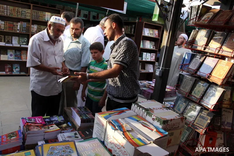 Palestinians search for books during the opening ceremony of the book exhibition which organised by the Ministry of Culture in Gaza city on Oct. 5,2011. Palestinian Prime Minister in Gaza Strip, Ismail Haniya attended th...