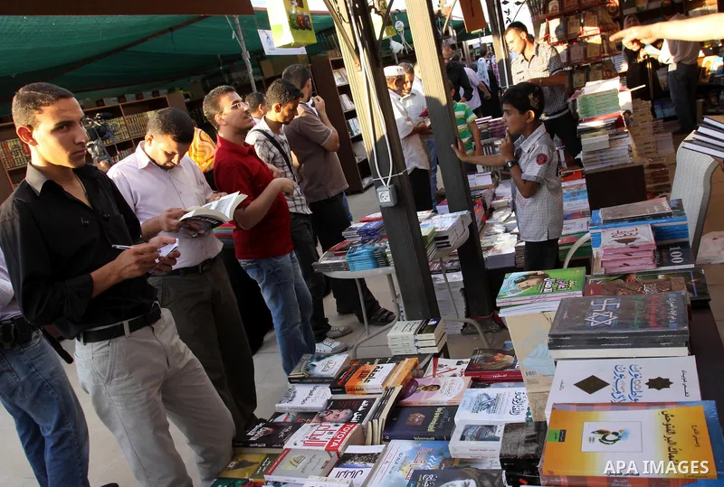 Palestinians search for books during the opening ceremony of the book exhibition which organised by the Ministry of Culture in Gaza city on Oct. 5,2011. Palestinian Prime Minister in Gaza Strip, Ismail Haniya attended th...