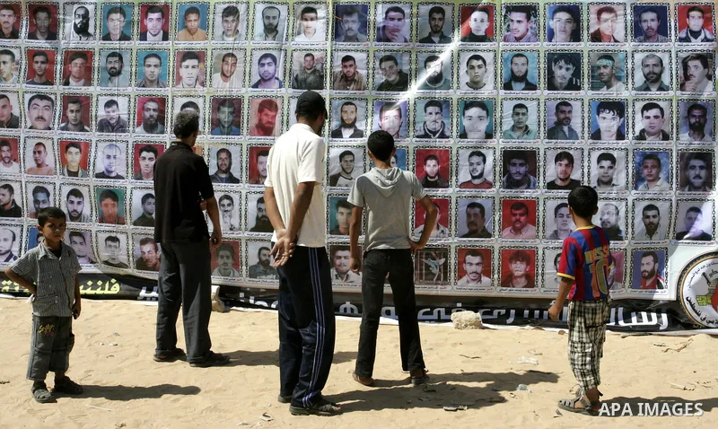 Palestinians take part in a protest in a solidarity tent with prisoners jailed in Israeli in Rafah, southern Gaza Strip on Oct, 6, 2011, to show their solidarity with Palestinian prisoners held in Israeli jails. Hundreds...