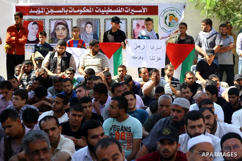 Palestinian Muslim worshippers attend Friday prayer next to the Red Cross building in Gaza City as they call for the release of Palestinian prisoners from Israeli jails and support of inmates in hunger strike on October...