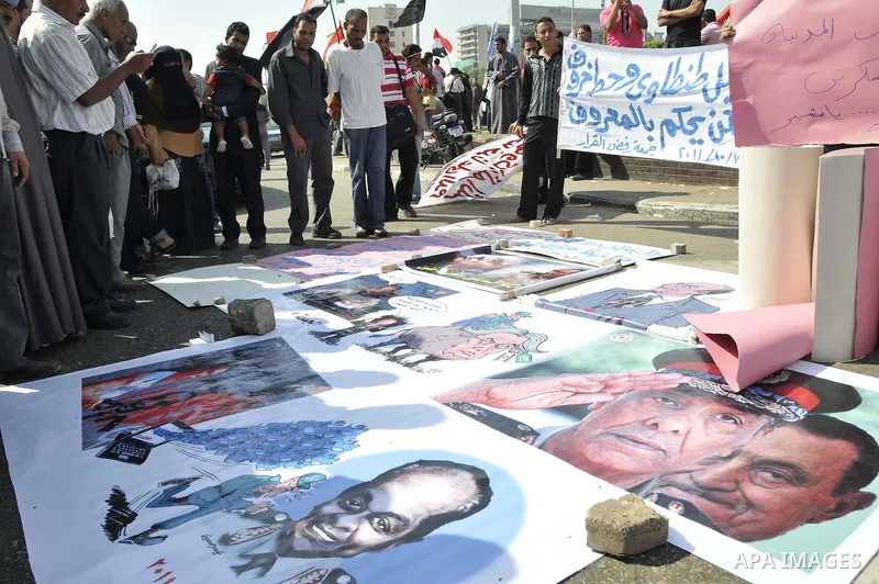 Egyptian demonstrators take part in a weekly protest in Tahrir Square, Cairo, Egypt, Friday, Oct. 7, 2011. Thousands of Egyptians protested Friday against the country's military rulers decision to retain the much hated e...