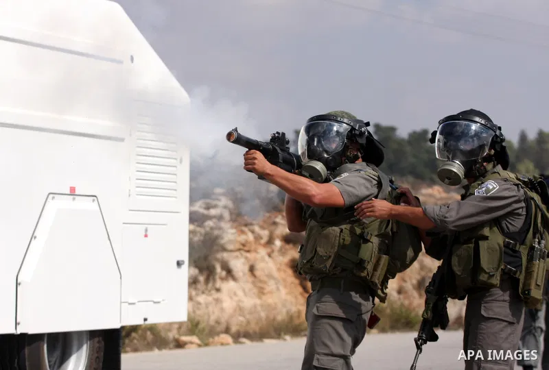Israeli soldiers fire tear gas canister to disperse Palestinian stone throwers during clashes following a weekly demonstration against Israeli settlement expansion, in the West Bank village of Nabi Saleh, on October 7, 2...