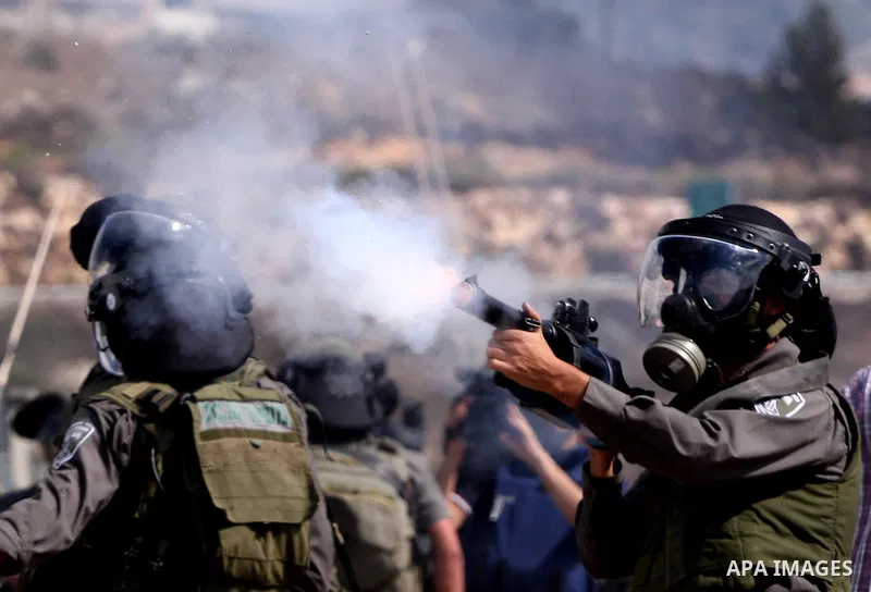Israeli soldiers fire tear gas canister to disperse Palestinian stone throwers during clashes following a weekly demonstration against Israeli settlement expansion, in the West Bank village of Nabi Saleh, on October 7, 2...