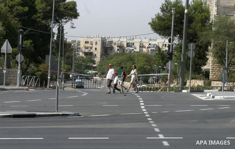 Israelis walks in the middle of an empty street during the Jewish holiday of Yom Kippur in Jerusalem, Saturday, Oct. 8, 2011. Yom Kippur, or "Day of Atonement," is the holiest of Jewish holidays when observant Jews atone...