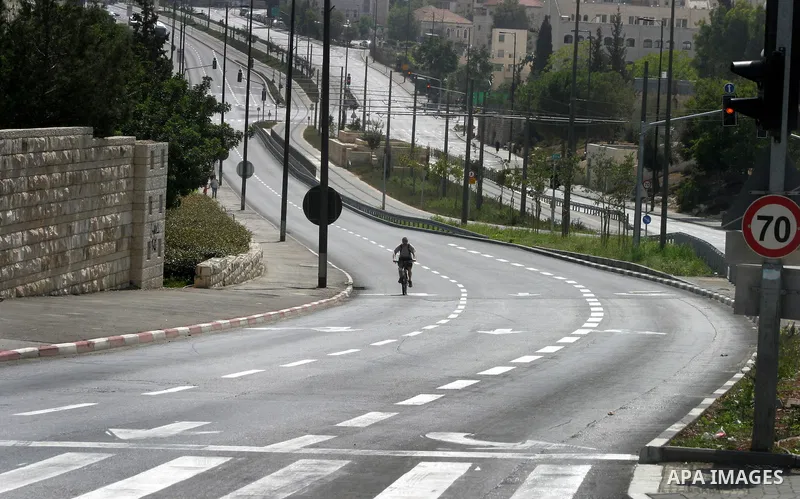 Israelis walks in the middle of an empty street during the Jewish holiday of Yom Kippur in Jerusalem, Saturday, Oct. 8, 2011. Yom Kippur, or "Day of Atonement," is the holiest of Jewish holidays when observant Jews atone...